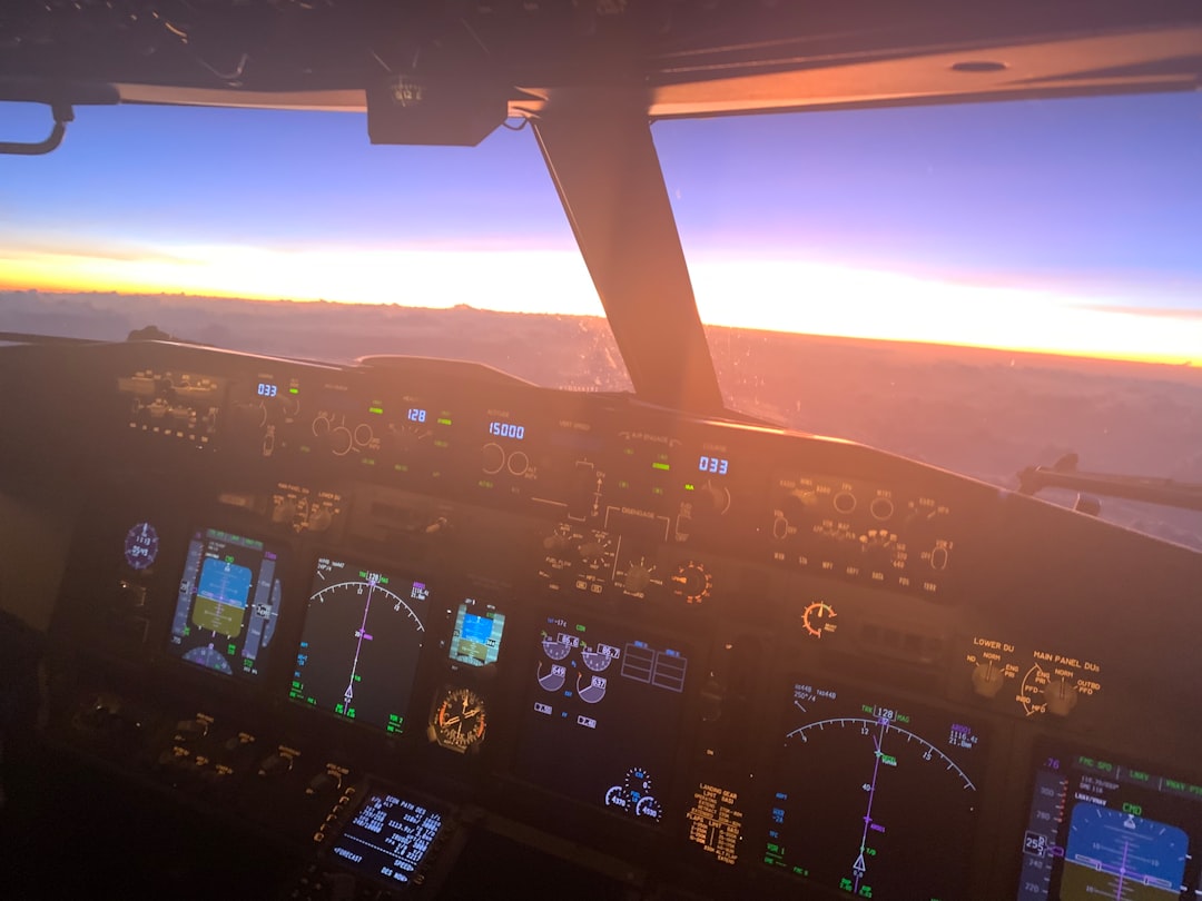 Dark aeroplane cockpit with unlit instruments, symbolising blind navigation.