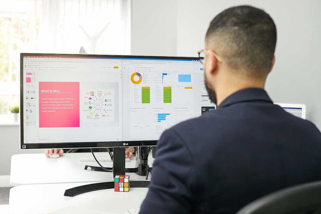 Frustrated SME owner in front of a computer screen displaying complex and useless graphs and figures.